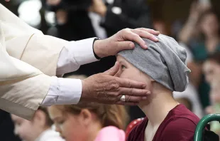 Pope Francis embraces a patient at Krakow's Prokocim University Pediatric Hospital, July 29, 2016.   L'Osservatore Romano.