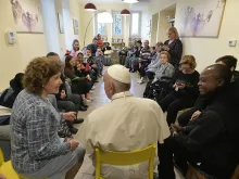 Pope Francis visits with residents of CasAmica, a home for the indigent sick, in a Roman suburb Dec. 7, 2018. 