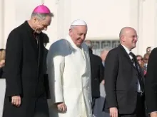 Pope Francis walks with Archbishop Georg Ganswein in St. Peter's Square during the Wednesday general audience on Dec. 4, 2013 