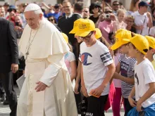 Pope Francis walks with young people during his general audience June 13, 2018. 