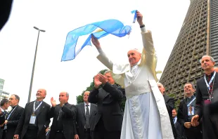 Pope Francis waves an Argentine flag during World Youth Day 2013.   Alex Mazzullo/JMJ Rio 2013 via Flickr (CC BY-NC-SA 2.0).