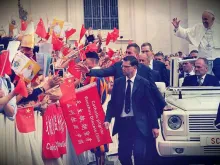 Pope Francis waves at pilgrims from China at the general audience Sept. 7, 2016. 