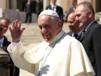 Pope Francis waves to pilgrims in St. Peter's Square during his April 20, 2016 general audience. 
