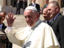 Pope Francis waves to pilgrims in St. Peter's Square during his April 20, 2016, general audience. 