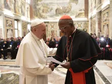 Pope Francis greets Cardinal John Njue of Nairobi, president of the International Catholic Migration Commission, at the Vatican's Clementine Hall, March 8, 2018. 