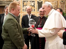 Pope Francis receives a gift from a Special Olympian at the Vatican's Clementine Hall, Feb. 16, 2017. 