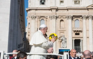 Pope Francis holds a soccer ball in St. Peter's Square in 2015.   Vatican Media.