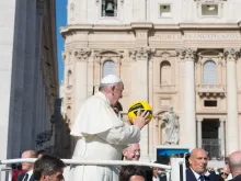 Pope Francis holds a soccer ball in St. Peter's Square in 2015. 
