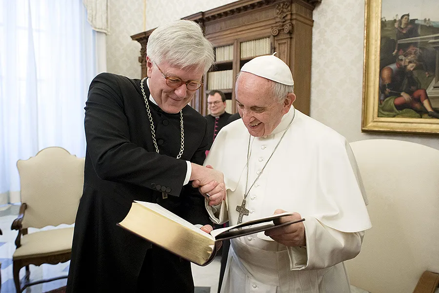 Pope Francis examines a book with Heinrich Bedford-Strohm, chairman of the Evangelical Church in Germany, at an ecumenical meeting at the Vatican, Feb. 6, 2017. ?w=200&h=150