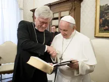 Pope Francis examines a book with Heinrich Bedford-Strohm, chairman of the Evangelical Church in Germany, at an ecumenical meeting at the Vatican, Feb. 6, 2017. 