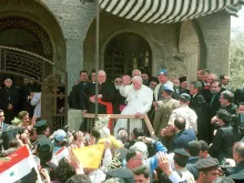 Pope John Paul II, center, waves to a crowd of wellwishers May 7, 2001 during a visit to the demilitarized city of Qunaitra, Syria in the Golan Heights. 