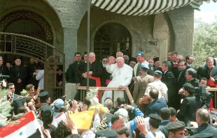 Pope John Paul II, center, waves to a crowd of wellwishers May 7, 2001 during a visit to the demilitarized city of Qunaitra, Syria in the Golan Heights.   Courtney Kealy/Newsmakers
