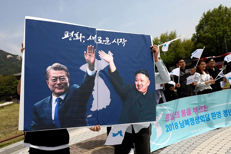 Posters of South Korean President Moon Jae-In and North Korean leader Kim Jong-Un during a rally on April 26, 2018 in Seoul. ?w=200&h=150