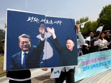 Posters of South Korean President Moon Jae-In and North Korean leader Kim Jong-Un during a rally on April 26, 2018 in Seoul. 