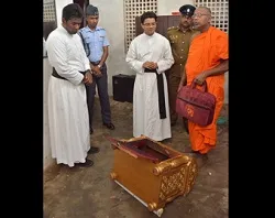 Priests, a Buddhist monk and police inspect a desecrated tabernacle. (?w=200&h=150