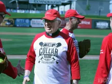 Bishop Fabian Bruskewitz, bishop emeritus of Lincoln, greets fellow priests and teammates at Werner Park in Papillion, Neb., before the I-80 Collar Series, June 21, 2015. 