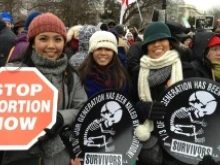 Pro-life marchers hold anti-abortion signs at the March for Life, Jan. 25, 2013. 