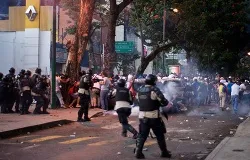  Protesters run from riot police on Feb. 15, 2014 in Altamira, Caracas, Venezuela. ?w=200&h=150