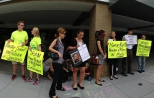 Protesters stand in front of an embassy in Washington DC to protest human rights violations in that country. Courtesy of the ACLJ.