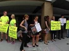 Protesters stand in front of an embassy in Washington DC to protest human rights violations in that country. Courtesy of the ACLJ.