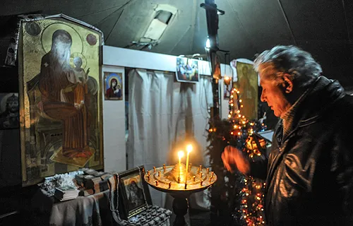 Protestors take refuge and pray for peace in one of two tent-chapels on Maidan Square in Kiev. ?w=200&h=150