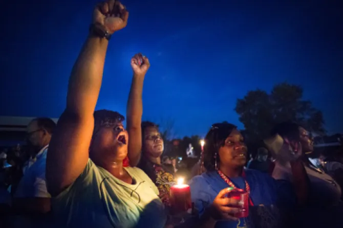 Protestors held candles as they shouted hands up during a protest in Ferguson Credit Lisa JohnstonSt Louis Review CNA