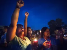 Protestors held candles as they shouted hands up during a protest in Ferguson. 