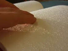 Reading braille. 