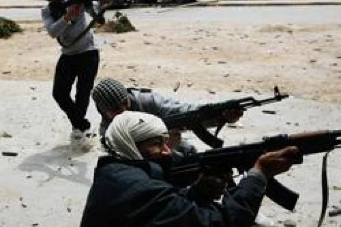 Rebel fighters fire at government loyalist troops during street fighting in Libya Credit Chris Hondros Getty Images Getty Images News CNA World Catholic News 8 23 11