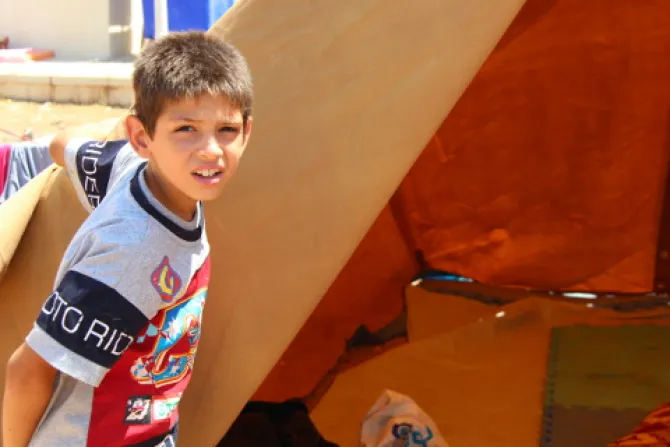 Refugee child in Ankaway Erbil at the opening of his tent Catholic News Agency Credit Maria Lozano CNA 81414