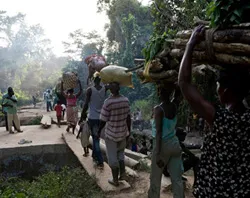 Refugees from Ivory Coast make their way across a plank bridge on their way to Liberia. ?w=200&h=150