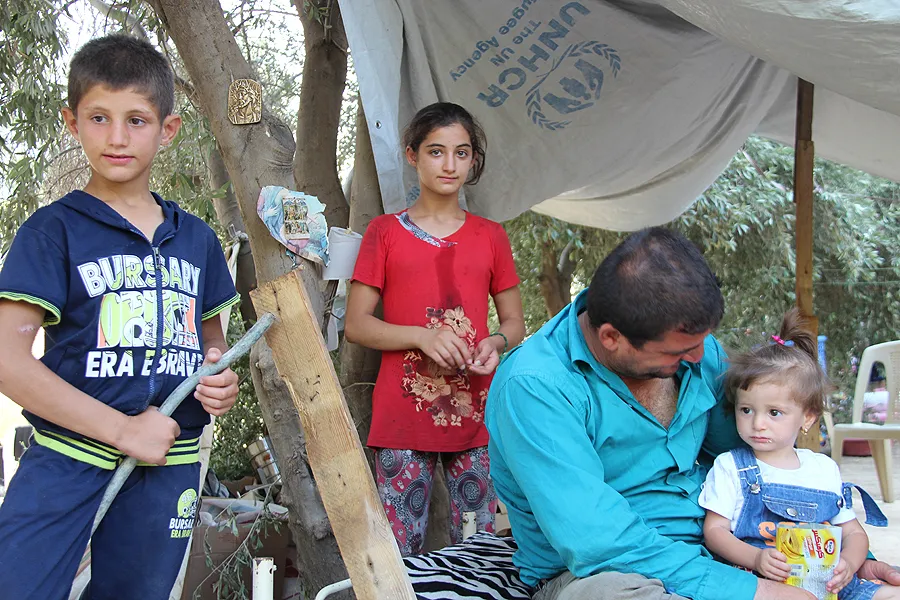 Refugees from Iraq fled their homes and now take shelter at a refugee camp. ?w=200&h=150