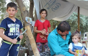 Refugees from Iraq fled their homes and now take shelter at a refugee camp.   Aid to the Church in Need.