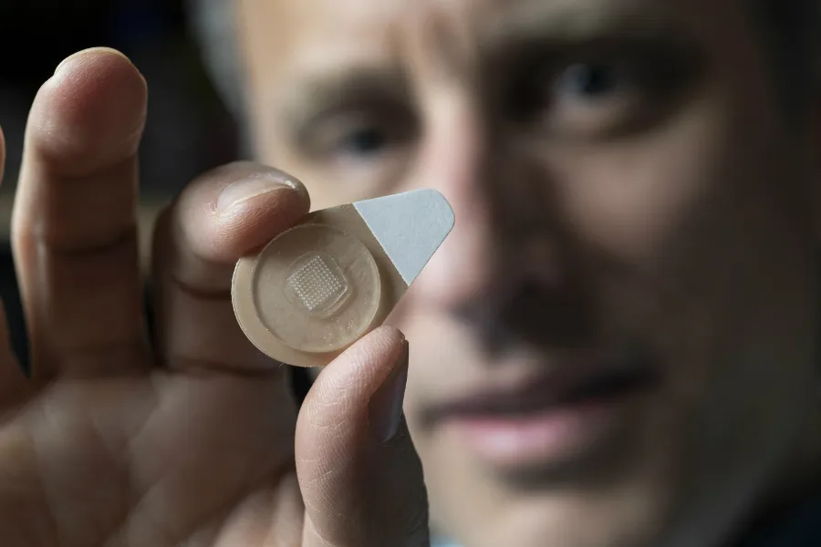 Regents Professor Mark Prausnitz holds an experimental microneedle contraceptive skin patch. ?w=200&h=150