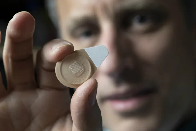 Regents Professor Mark Prausnitz holds an experimental microneedle contraceptive skin patch Credit Christopher Moore Georgia Tech CNA