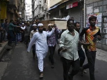 Relatives and residents carry the coffin of a victim during a funeral procession after a fire tore through apartment blocks in Dhaka, Feb. 21, 2019. 