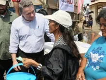 Rep. Smith joins a clean water distribution line operated by Catholic Relief Services and USAID to talk with victims of the typhoon. 