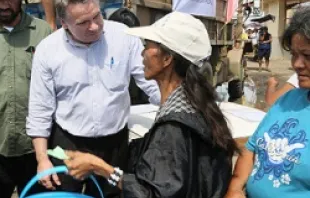 Rep. Smith joins a clean water distribution line operated by Catholic Relief Services and USAID to talk with victims of the typhoon.   Jim Stipe/Catholic Relief Services.