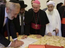 Representatives of the Abrahamic religions sign a declaration on end-of-life issues at the Vatican Oct. 28, 2019. 