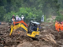 Rescue workers search for missing people at a landslide site in Kerala state Aug. 10, 2020. 