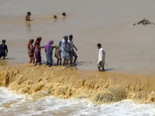 Residents wade through flood waters in Karachi, Pakistan July 31, 2019. 