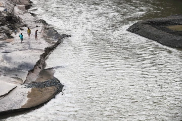 Residents walk along the bank of the Vivi River near the area where a bridge was washed away on October 20 2017 in Utuado Puerto Rico Credit Mario Tama Getty Images CNA