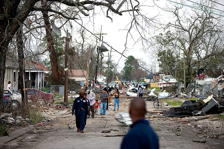 Residents walk down a street along Chef Menture Ave after a tornado touched down in the eastern part of the city on Feb. 7, 2017 in New Orleans. ?w=200&h=150