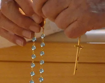 A Catholic prays the Rosary. ?w=200&h=150