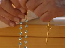 A Catholic prays the Rosary. 