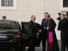 Archbishop Georg Gaenswein, prefect of the papal household, greets Russian president Vladimir Putin upon his arrival at the Vatican, June 10, 2015. 
