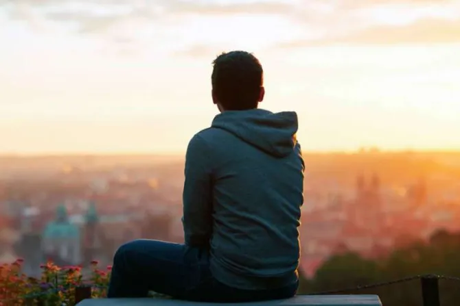 Sad young man sitting and looking at the sunset Credit Alexmom  Shutterstock