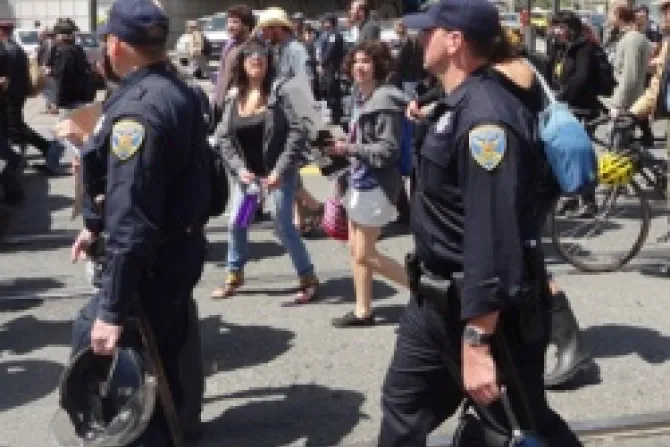 San Francisco Police with riot helmets walk along as protestors heckle them during the May Day protests May 1 2012 Credit Lily Rothrock CC BY 20 CNA US Catholic News 5 3 12