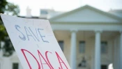 A DACA protest sign is waved outside of the White House on Sept. 5, 2017.
