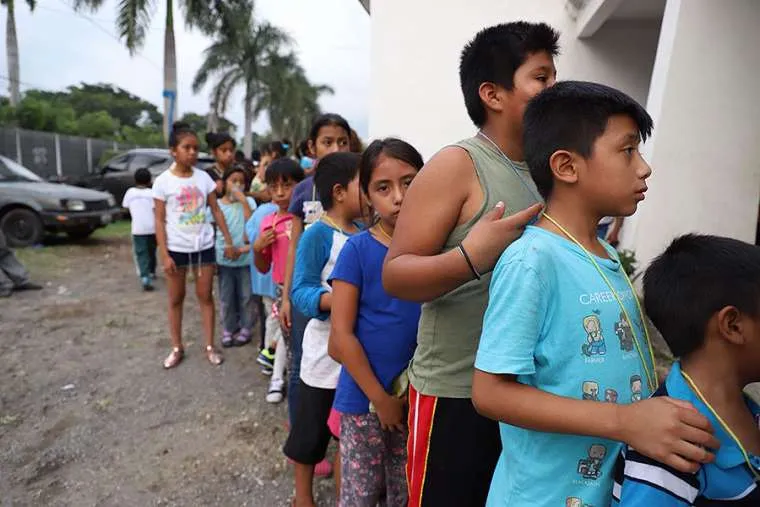 Children queue outside a shelter in Guatemala. ?w=200&h=150